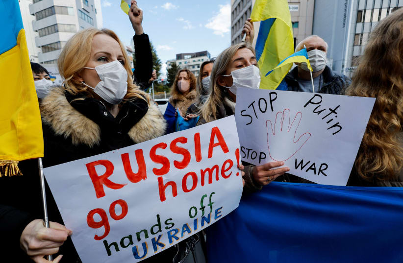  Ukrainians residing in Japan hold placards and flags during a protest rally denouncing on Russia over its actions in Ukraine, near Russian embassy in Tokyo (photo credit: REUTERS/ISSEI KATO)