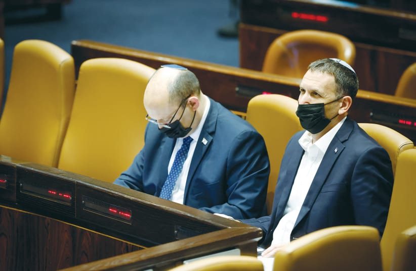  RELIGIOUS SERVICES Minister Matan Kahana sits next to Prime Minister Naftali Bennett during a session in the Knesset plenum earlier this month. (photo credit: OLIVIER FITOUSSI/FLASH90)