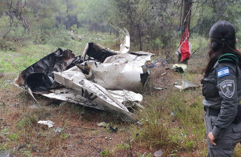  A Border Police officer looks on at the remains of a crashed aircraft in Jerusalem Hills on February 26, 2022 (photo credit: ISRAEL FIRE AND RESUCE SERVICES)