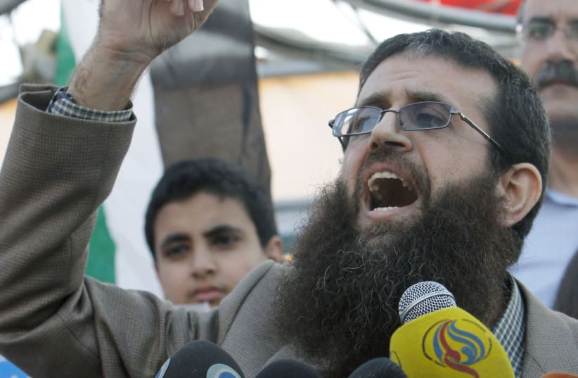  Palestinian Islamic Jihad leader Khader Adnan gestures as he speaks during a rally honoring him following his release, near the West Bank city of Jenin July 12, 2015. (photo credit: ABED OMAR QUSINI/REUTERS)