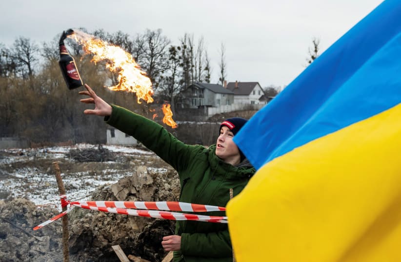  A civilian trains to throw Molotov cocktails to defend the city, as Russia's invasion of Ukraine continues, in Zhytomyr, Ukraine March 1, 2022 (photo credit: Viacheslav Ratynskyi/Reuters)