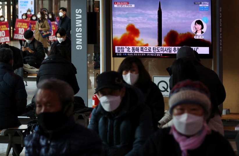  People watch a TV broadcasting a news report on North Korea's firing a ballistic missile off its east coast, in Seoul, South Korea, March 5, 2022 (photo credit: KIM HONG-JI/ REUTERS)