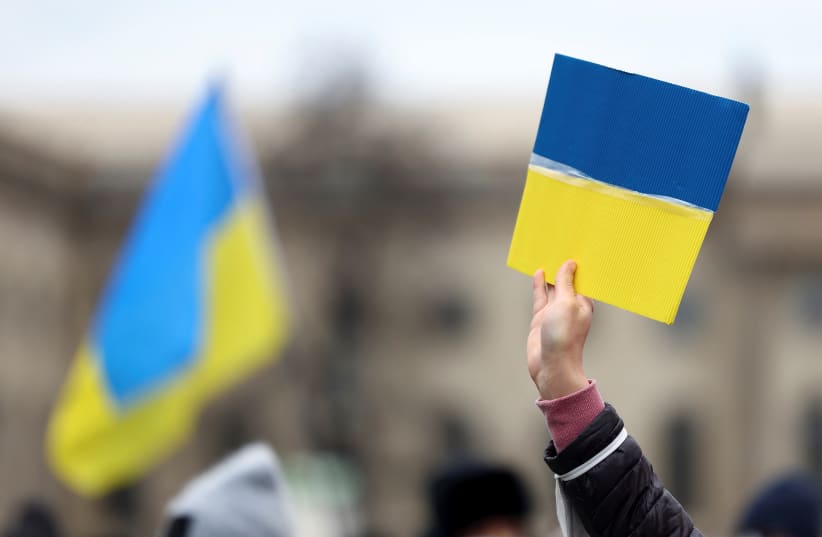  A person holds a representation of the Ukrainian flag during the demonstration "For your and for our freedom! Voices on the War in Ukraine - live", following Russia's invasion of Ukraine, at the Bebelplatz square in Berlin, Germany, March 6, 2022 (photo credit: REUTERS/LISI NIESNER)