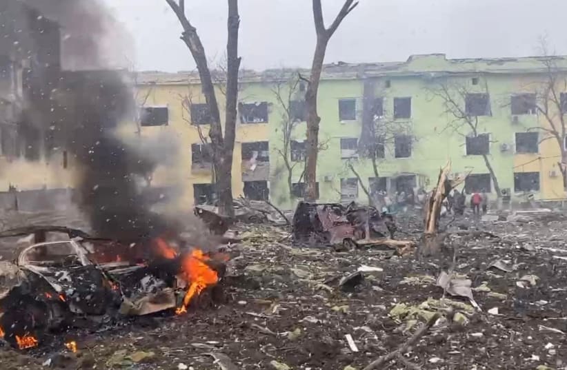  A view shows cars and a building of a hospital destroyed by an aviation strike amid Russia's invasion of Ukraine, in Mariupol, Ukraine, in this handout picture released March 9, 2022.  (photo credit: Press service of the National Police of Ukraine/Handout via REUTERS)