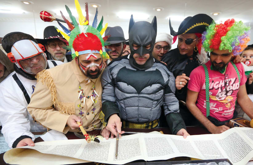  Men dressed as superheroes read from Megilat Esther at a synagogue in Jerusalem's Arnona neighborhood. (photo credit: MARC ISRAEL SELLEM)