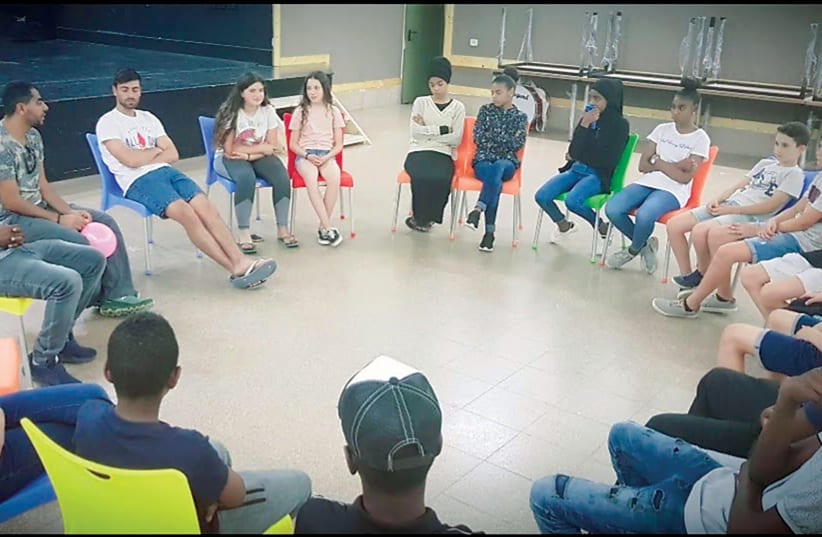  Jewish children from the Bnei Shimon Regional Council introduce themselves to Bedouin teens from Rahat at Rahat’s community center. (photo credit: RAMZI ALOBRA)