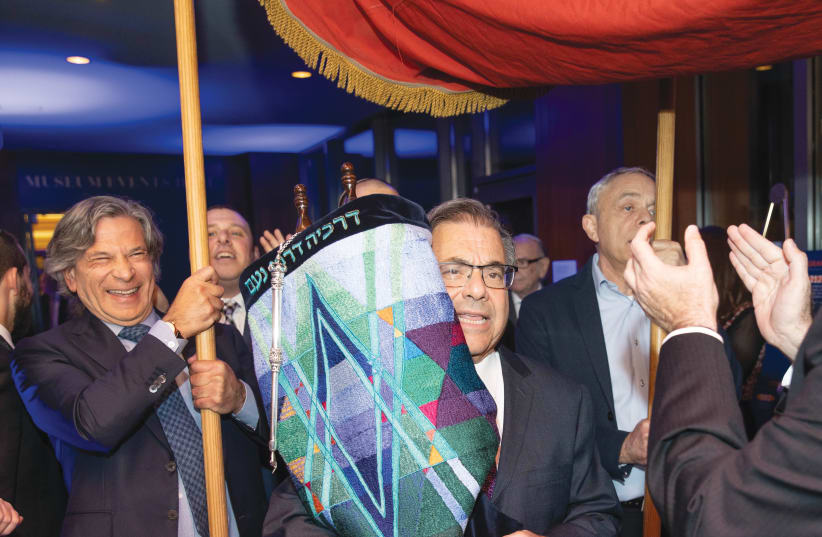  RABBI SHLOMO RISKIN dances with the Torah at the Ohr Torah Stone annual dinner, 2019. (photo credit: Brian Berkowitz)