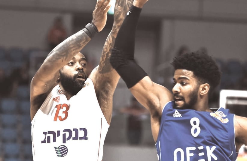 KC RIVERS (13) follows through on a shot in his Hapoel Jerusalem debut this week, in which he was key contributor in a 89-88 victory over Bnei Herzliya. (photo credit: DOV HALICKMAN PHOTOGRAPHY)