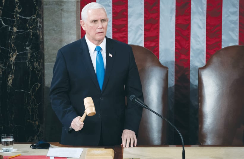  THEN-US VICE President Mike Pence officiates, as a joint session of the House and Senate convenes on January 6, 2021 to confirm the Electoral College votes cast in the November 2020 election.  (photo credit: SAUL LOEB/REUTERS)
