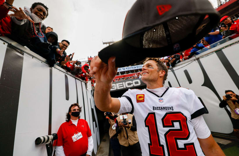   Tampa Bay Buccaneers quarterback Tom Brady (12) hands his hat to a fan after beating the Philadelphia Eagles 31-15 in a NFC Wild Card playoff football game at Raymond James Stadium (photo credit: Nathan Ray Seebeck-USA TODAY Sports TPX)