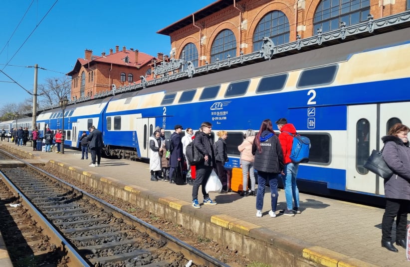  Refugees at the Suceava train station prepare to board a train that will take them to their next destination inside Romania on March 15, 2022. (photo credit: MAYA MARGIT/THE MEDIA LINE)
