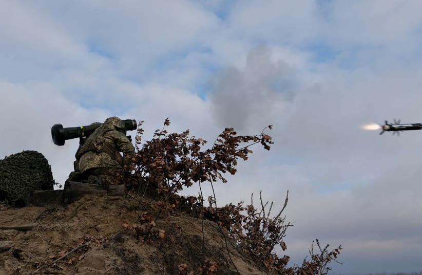 Service members of the Ukrainian Armed Forces fire a Javelin anti-tank missile during drills at a training ground in an unknown location in Ukraine, in this handout picture released February 18, 2022. (photo credit: UKRAINIAN JOINT FORCES OPERATION PRESS SERVICE/HANDOUT VIA REUTERS)