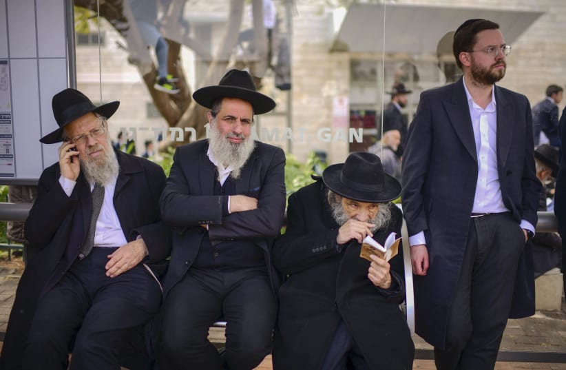  Ultra-Orthodox Jews gather during the funeral ceremony of Rabbi Chaim Kanievsky in the streets near the cemetery  in the city of Bnei Brak, on March 20, 2022 (photo credit: TOMER NEUBERG/FLASH90)