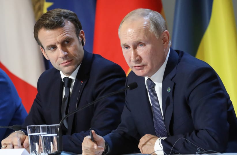  French President Emmanuel Macron and Russian President Vladimir Putin give a press conference after a summit on Ukraine at the Elysee Palace in Paris, December 9, 2019 (photo credit: VIA REUTERS)