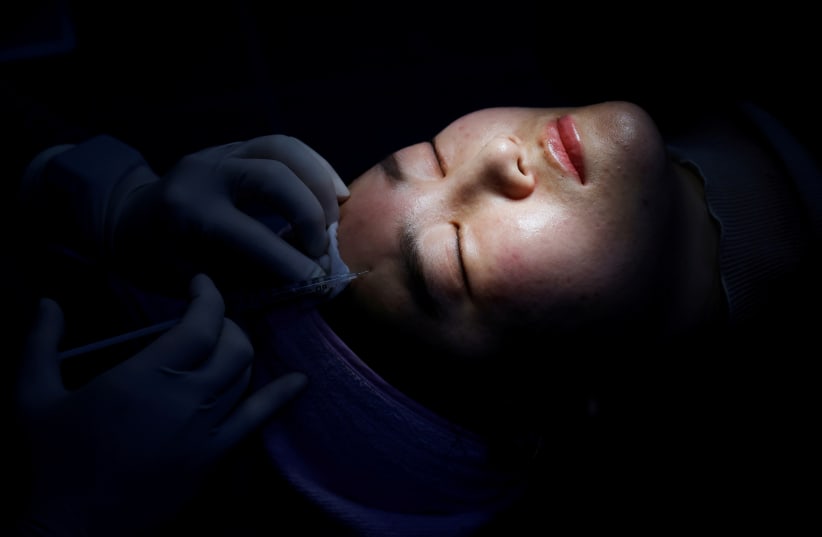  Kim Seul-ki gets Botox injection, amid the coronavirus disease (COVID-19) pandemic in Seoul, South Korea, December 15, 2020. Picture taken on December 15, 2020.  (photo credit: REUTERS/KIM HONG-JI)