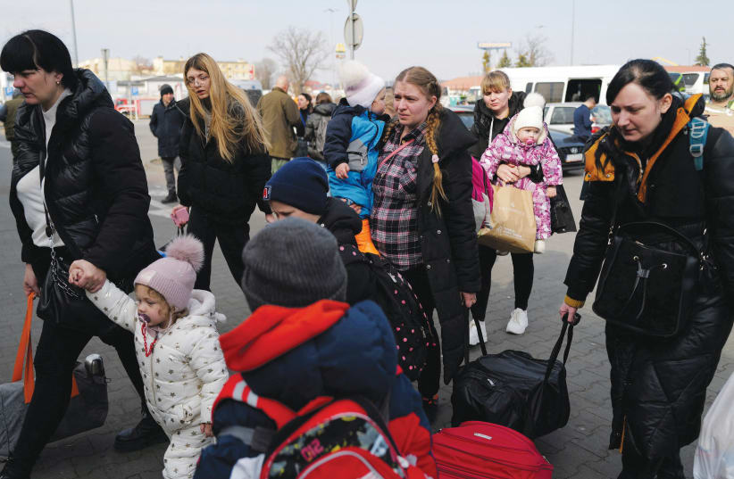  WOMEN AND their children who fled Russia’s invasion of Ukraine arrive at a humanitarian aid center in Przemysl, Poland. (photo credit: ZOHRA BENSEMRA/REUTERS)