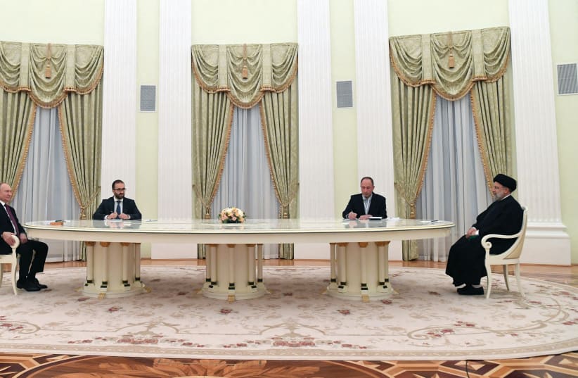  RUSSIAN PRESIDENT Vladimir Putin and his Iranian counterpart Ebrahim Raisi sit at opposite ends of the long Kremlin table in January. (photo credit: SPUTNIK/REUTERS)
