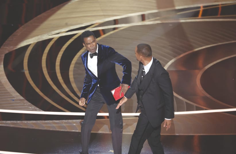  Will Smith (right) strikes Chris Rock onstage during the Academy Awards ceremony on Sunday. (photo credit: Myung Chun/Los Angeles Times/TNS)