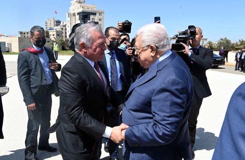  Jordan's King Abdullah shakes hands with Palestinian President Mahmoud Abbas in Ramallah, in the Israeli-occupied West Bank, March 28, 2022. (photo credit: PALESTINIAN PRESIDENT OFFICE (PPO)/HANDOUT VIA REUTERS)