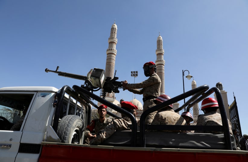  Military policemen ride on the back of a patrol truck at the site of a funeral of Houthi fighters killed during recent fighting against government forces, in Sanaa, Yemen December 6, 2021 (photo credit: KHALED ABDULLAH/REUTERS)