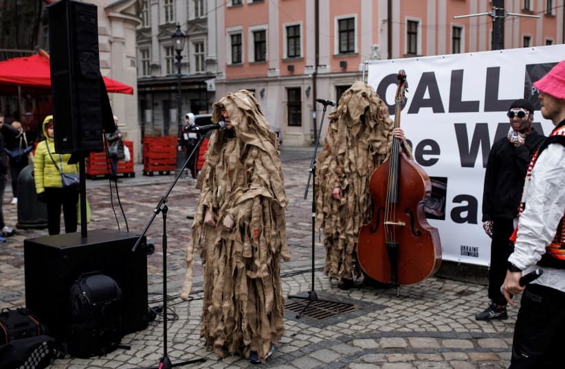  A member of Kalush Orchestra, Ukraine's representative for the 2022 Eurovision contest, performs at Rynok square, as Russia's attack on Ukraine continues, in Lviv, Ukraine, April 2, 2022 (photo credit: REUTERS/ALKIS KONSTANTINIDIS)