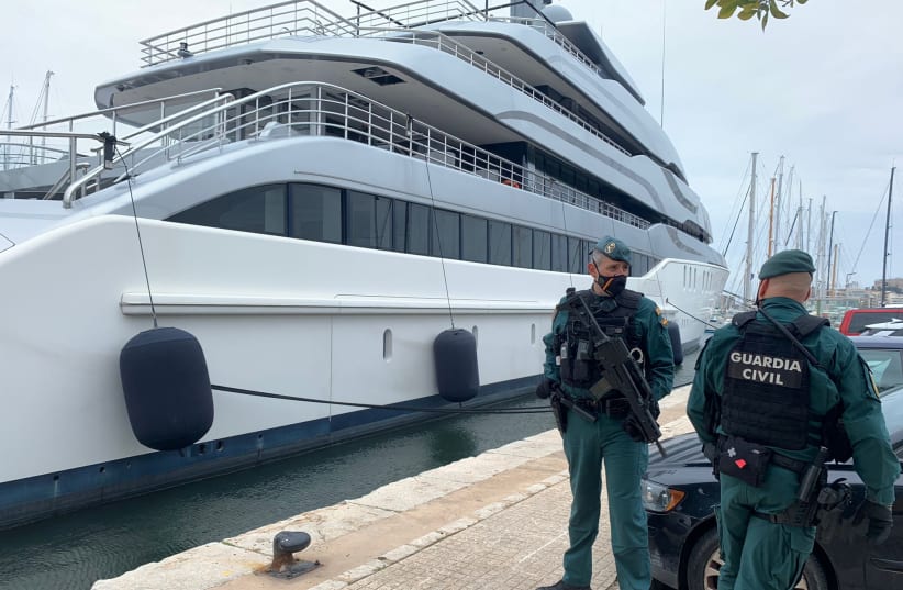  Spanish Civil Guards stand by the Tango superyacht, suspected to belong to a Russian oligarch, as it is docked at the Mallorca Royal Nautical Club, in Palma de Mallorca, in the Spanish island of Mallorca, Spain, April 4, 2022. (photo credit: Juan Poyates Oliver/Handout via REUTERS)