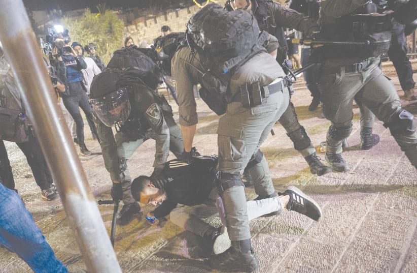  ISRAELI POLICE arrest a man during confrontations with protesters at Damascus Gate of Jerusalem’s Old City on April 4, 2022. (photo credit: YONATAN SINDEL/FLASH90)