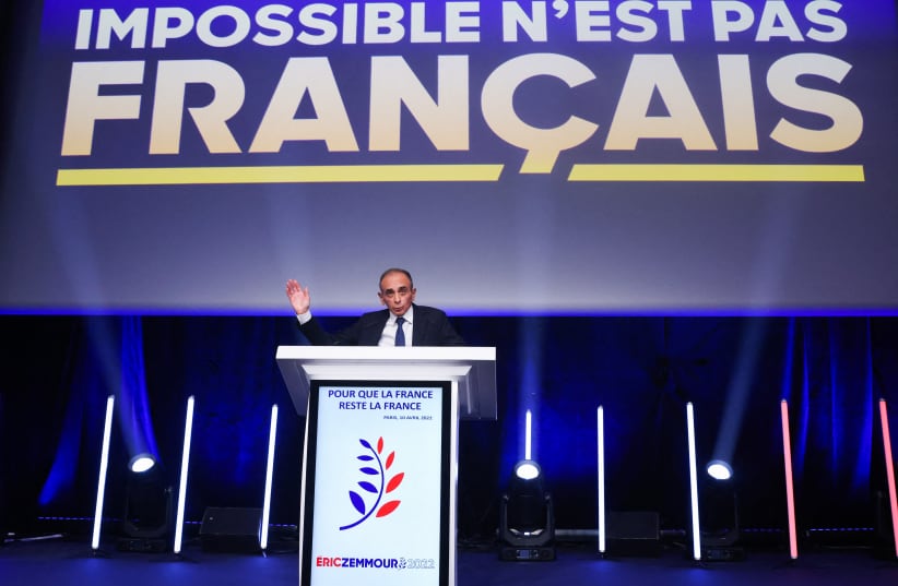  French far-right commentator Eric Zemmour, leader of far-right party "Reconquete!" and candidate for the 2022 French presidential election, gestures as he stands on a stage, after partial results in the first round of the 2022 French presidential election, in Paris, France April 10, 2022.  (photo credit: REUTERS/YVES HERMAN)