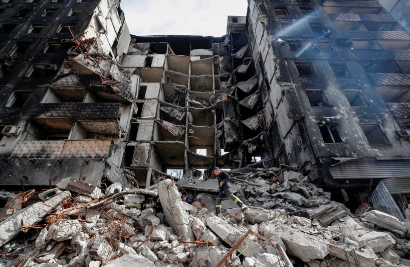  Emergency workers remove debris of a building destroyed in the course of the Ukraine-Russia conflict, in the southern port city of Mariupol, Ukraine April 10, 2022. (photo credit: REUTERS/ALEXANDER ERMOCHENKO)
