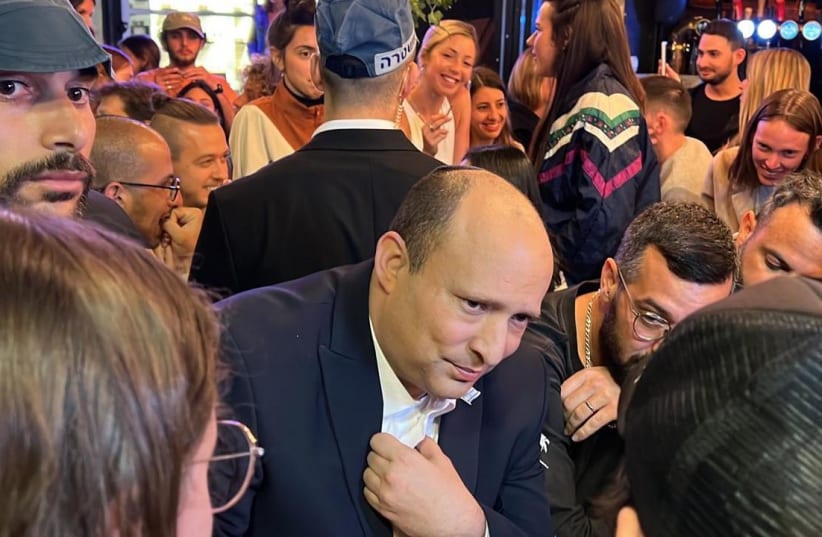 Prime Minister Naftali Bennett visits the Ilka Bar in Tel Aviv, Monday, April 11, 2022. (photo credit: Courtesy)