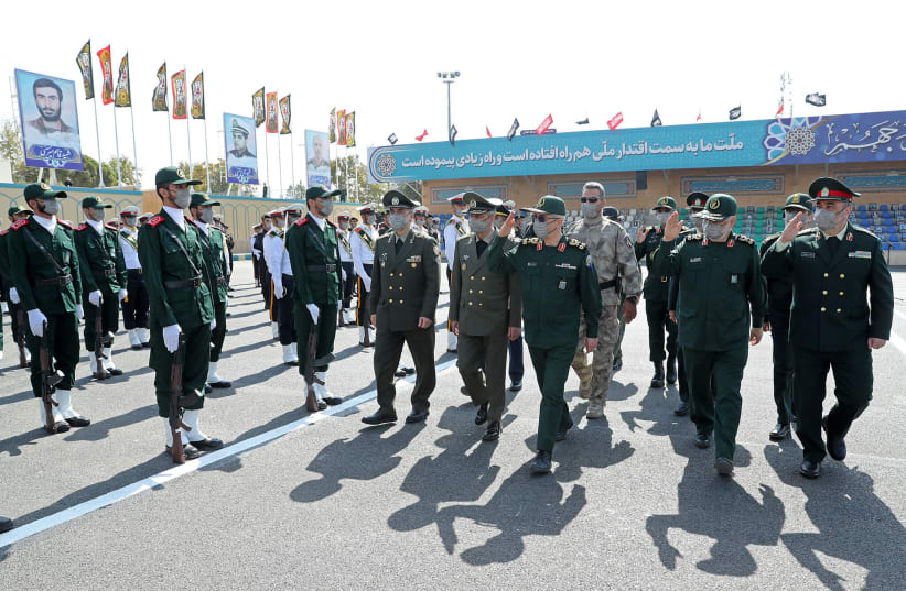Iranian commander-in-chief of the Islamic Revolutionary Guard Corps Hossein Salami, second from right, and Iran's Chief of General Staff Major General Mohammad Bagheri, third from left, attend the graduation ceremony of Imam Hussein Military University in Tehran, Oct. 3, 2021.  (photo credit: Iranian Leader Press Office/Handout/Anadolu Agency via Getty Images)