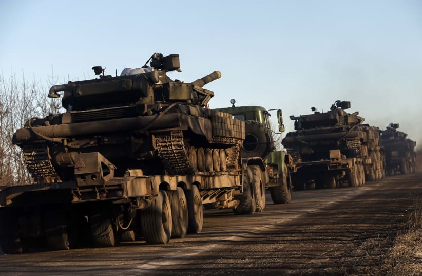  Military trucks from the Ukrainian armed forces transport tanks on the road near Artemivsk, eastern Ukraine, February 24, 2015. (photo credit: REUTERS/GLEB GARANICH)