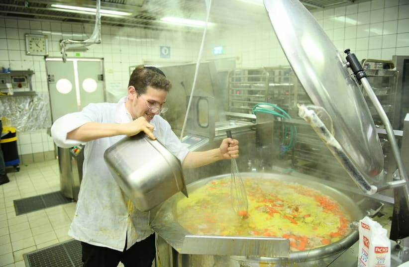 A cook prepares soup for group seder meals (photo credit: CHABAD)