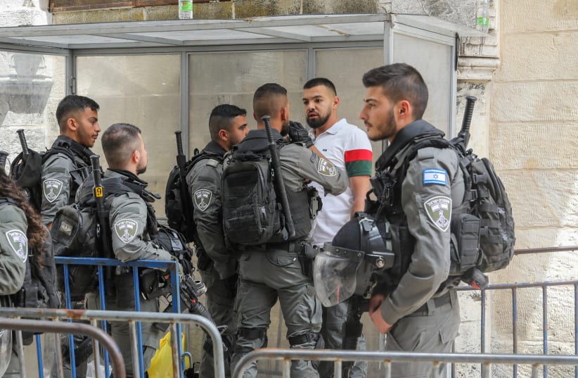 Israeli Border Police forces are seen confronting Palestinian men in Jerusalem's Old City on April 17, 2022 (photo credit: MARC ISRAEL SELLEM/THE JERUSALEM POST)