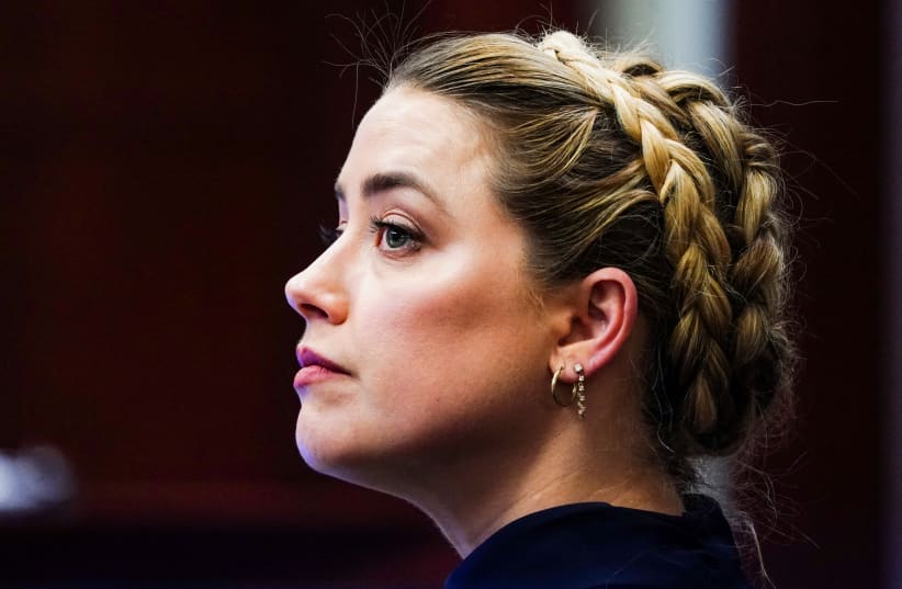 Actress Amber Heard sits in the courtroom during Johnny Depp's defamation case against her at the Fairfax County Circuit Court in Fairfax, Virginia, US, April 14, 2022. (photo credit: SHAWN THEW/POOL VIA REUTERS)