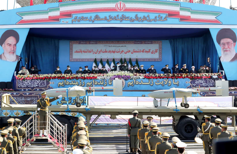  Iranian President Ebrahim Raisi and military commanders watch as military equipment passes by during a ceremony of the National Army Day parade in Tehran, Iran April 18, 2022. (photo credit: PRESIDENT WEBSITE/WANA (WEST ASIA NEWS AGENCY)/HANDOUT VIA REUTERS)