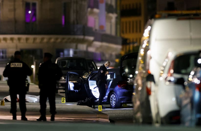 French police forensic officers inspect the scene of a shooting on the Pont Neuf bridge in Paris, France, April 25, 2022. (photo credit: REUTERS/Christian Hartmann TPX)