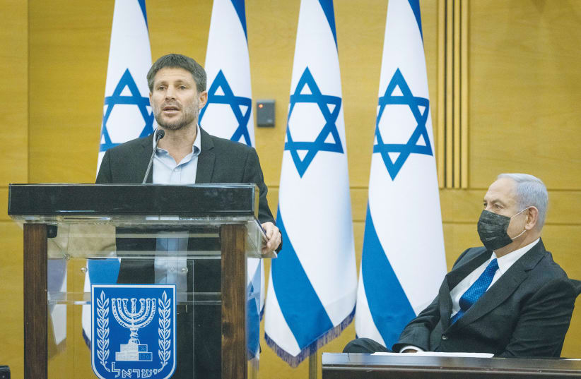  RELIGIOUS ZIONIST PARTY head MK Bezalel Smotrich speaks as opposition leader MK Benjamin Netanyahu looks on at an opposition meeting in the Knesset. (photo credit: YONATAN SINDEL/FLASH90)