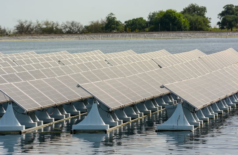INVESTING IN renewable energies: World's first patented floating solar energy system with adjustable panels, amde by Israeli hi-tech company Xfloat, at the Golan Height's Tzur water reservoir, April 10. (photo credit: MICHAL GILADI/FLASH90)