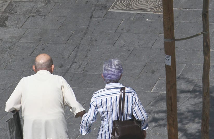  FOR THIS couple strolling in the city center, the sidewalk is empty – for now.  (photo credit: NATI SHOHAT/FLASH90)