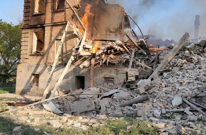  Debris is seen next to a partially collapsed building is seen, after a school building was hit as a result of shelling, in the village of Bilohorivka, Luhansk, Ukraine, May 8, 2022.  (photo credit: STATE EMERGENCY SERVICES/HANDOUT VIA REUTERS)