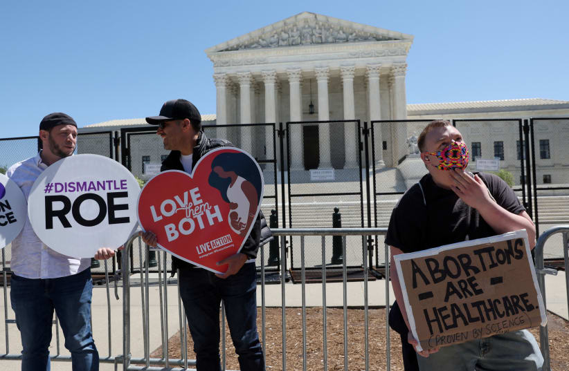  Protesters hold pro- and anti-abortion signs outside of the US Supreme Court building in Washington earlier this week. (photo credit: LEAH MILLIS/REUTERS)