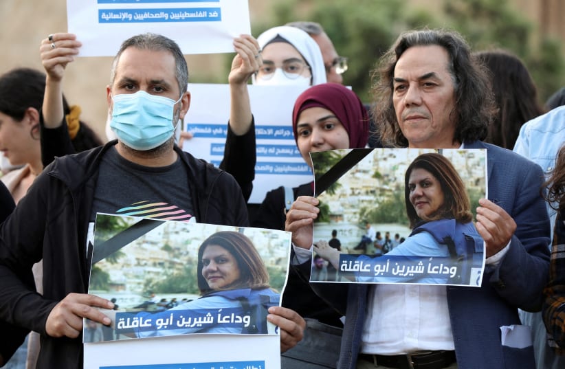  Lebanese journalists hold pictures of Al Jazeera reporter Shireen Abu Akleh, who was killed during a live fire exchange between Palestinians and IDF in Jenin, to express solidarity, in front of the UN building in Beirut, Lebanon May 11, 2022.  (photo credit: REUTERS/MOHAMED AZAKIR)