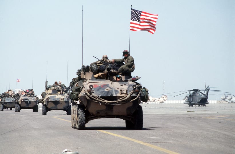 US Marines roll into Kuwait International Airport in light armored vehicles after the retreat of Iraqi forces from Kuwait during Operation Desert Storm. At right is a CH-53 Sea Stallion helicopter. (photo credit: US DEPARTMENT OF DEFENSE)