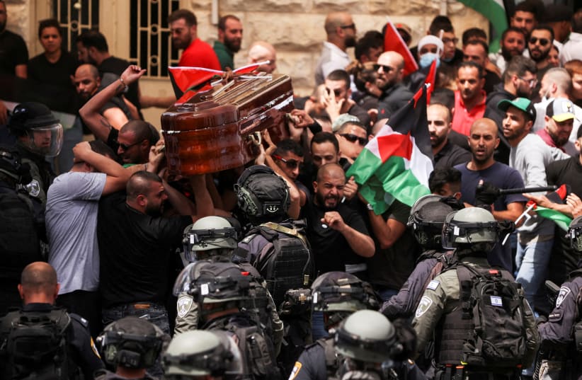 Family and friends carry the coffin of Al Jazeera reporter Shireen Abu Akleh, who was killed during an Israeli raid in Jenin, during her funeral in Jerusalem, May 13, 2022.  (photo credit: REUTERS/AMMAR AWAD)
