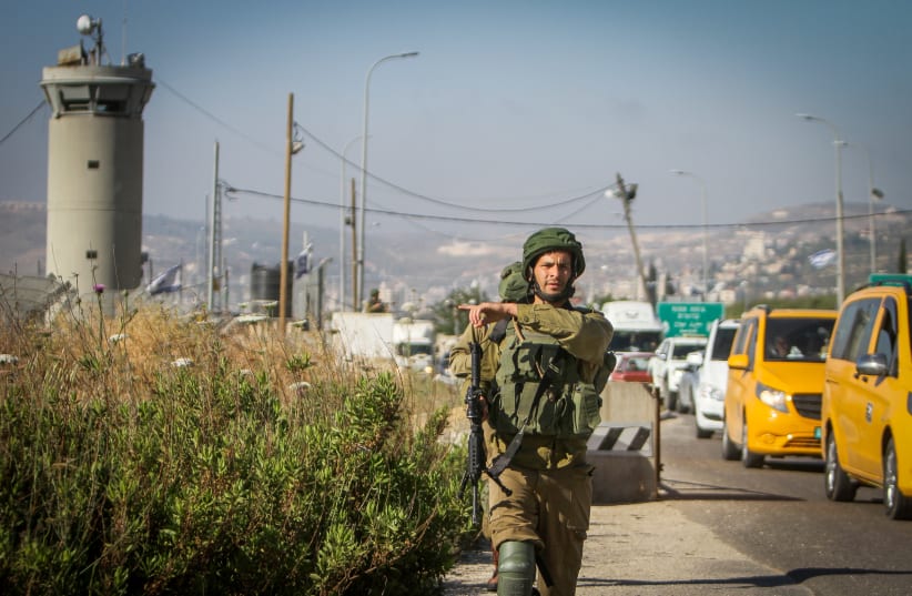  Israeli soldiers secure the scene after a Palestinian assailant attempted to stab Israeli soldiers, near the Hawara checkpoint, outside the West Bank city of Nablus, May 17, 2022.  (photo credit: NASSER ISHTAYEH/FLASH90)