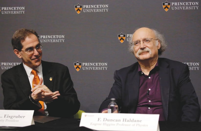  PRINCETON UNIVERSITY President Christopher Eisgruber applauds British-born scientist F. Duncan Haldane at a press conference after Haldane won the 2016 Nobel Prize for Physics.  (photo credit: DOMINICK REUTER/ REUTERS)