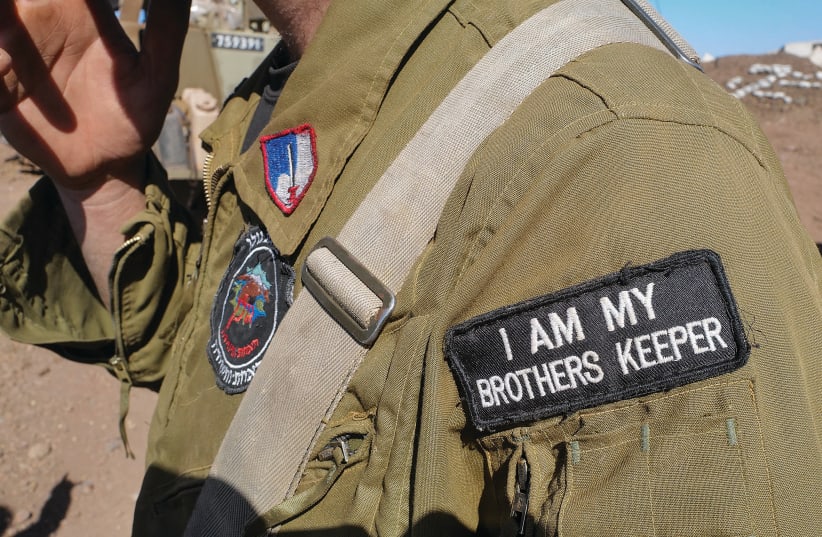  AN IDF SOLDIER posted near the Syrian border bears a message of responsibility on his uniform. The desire and thirst for security is as much part of the Israeli DNA as the Jewish and democratic pillars. (photo credit: MICHAEL GILADI/FLASH90)