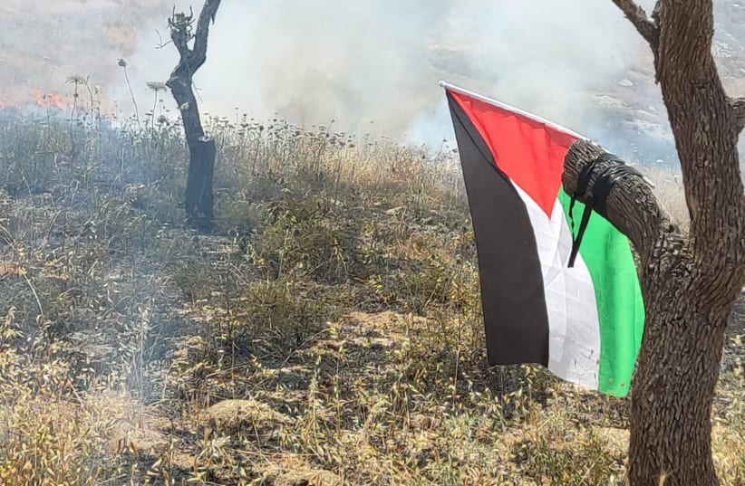  A Palestinian flag is found at the scene of a fire near the Israeli settler outpost of Kumi Ori in the West Bank, on May 29, 2022. (photo credit: FIRE AND RESCUE SERVICE)