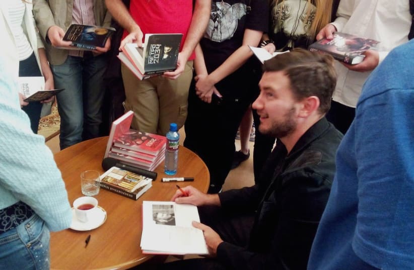  Russian-Israeli sci-fi writer Dmitry Glukhovsky at a book signing (Illustrative). (photo credit: Wikimedia Commons)